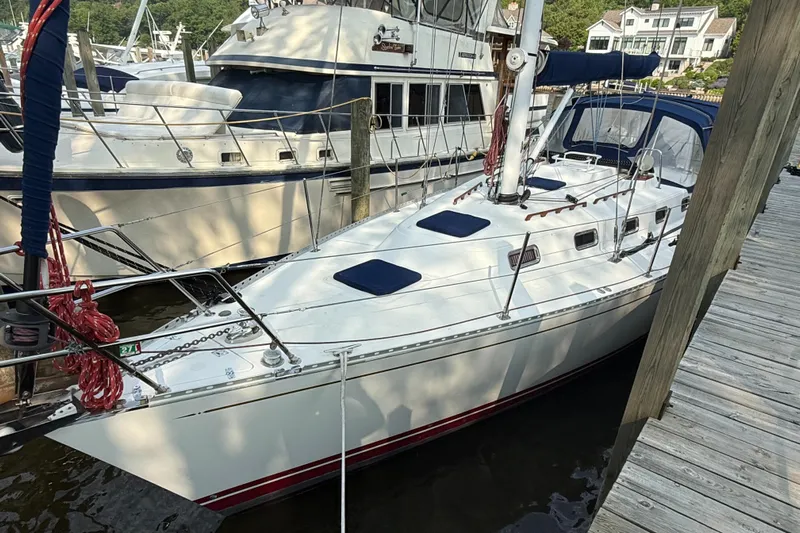 Nino Yacht Photos Pics Sailboat Tartan 4100, 2007 model, docked at marina with neighboring boats.