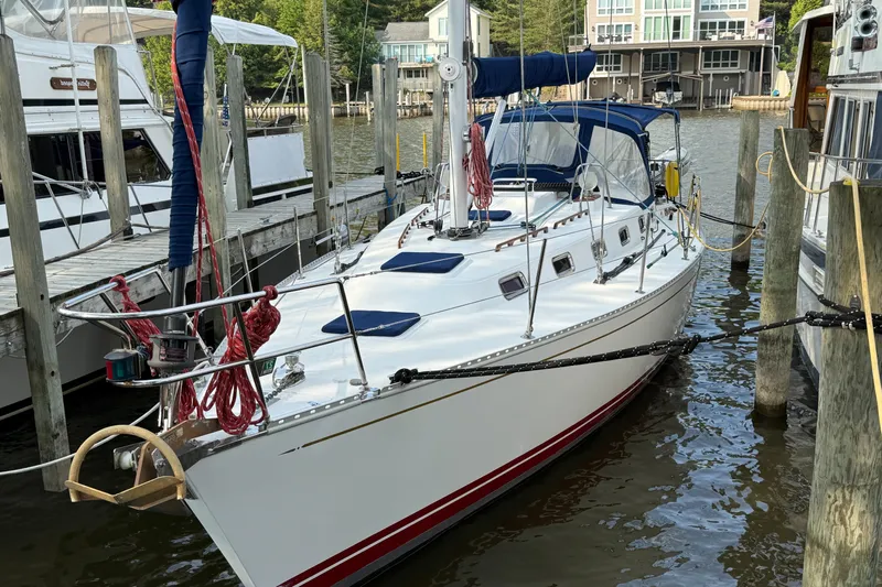 Nino Yacht Photos Pics 2007 Tartan 4100 sailboat docked in a marina, featuring sleek design and blue accents.
