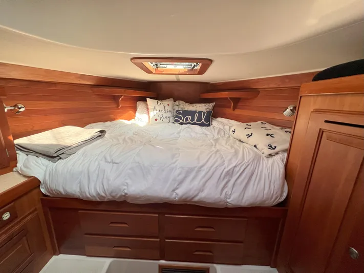 Nino Yacht Photos Pics Cozy cabin bedroom in 2007 Tartan 4100 sailboat with wooden interior and nautical decor.