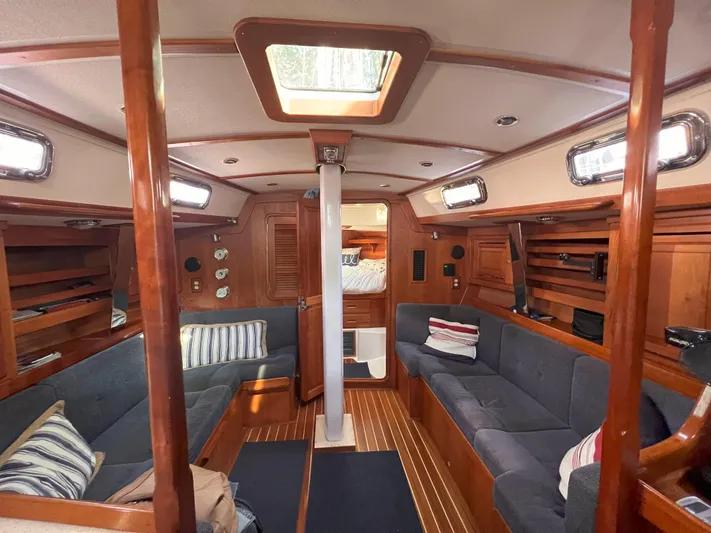 Nino Yacht Photos Pics Interior of 2007 Tartan 4100 sailboat with wood finish and blue seating.