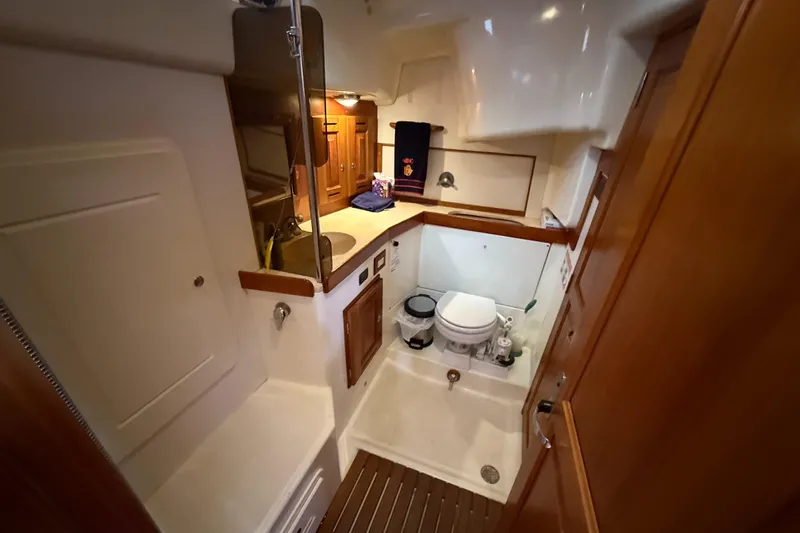 Nino Yacht Photos Pics Interior of 2007 Tartan 4100 yacht bathroom with wooden cabinetry and compact design.