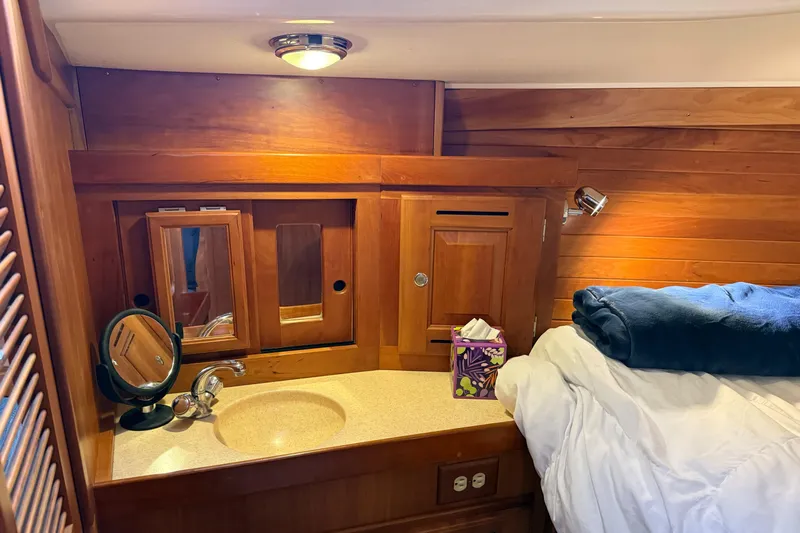 Nino Yacht Photos Pics Cozy Tartan 4100 yacht cabin with wooden interior, sink, and bed, 2007 model.