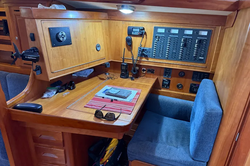 Nino Yacht Photos Pics Navigation station in a 2007 Tartan 4100 sailboat with control panel and seating.