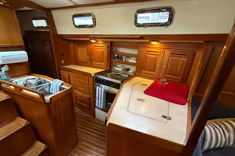 Nino Yacht Photos Pics Luxurious 2007 Tartan 4100 yacht interior with wooden cabinetry and modern kitchen amenities.