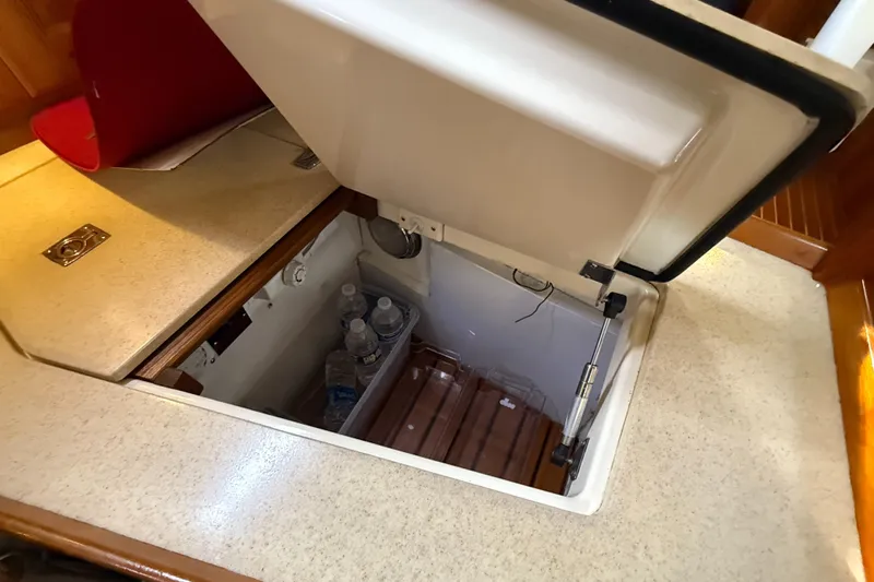 Nino Yacht Photos Pics Open hatch in 2007 Tartan 4100 yacht revealing storage with water bottles.