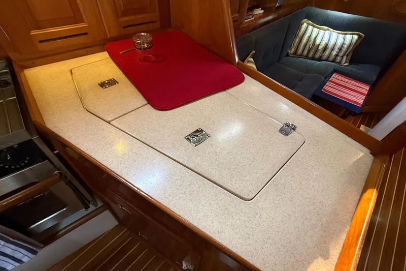 Nino Yacht Photos Pics Interior of 2007 Tartan 4100 yacht with galley countertop and cozy seating area.