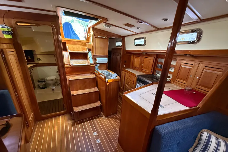 Nino Yacht Photos Pics Interior of 2007 Tartan 4100 sailboat with wooden cabinetry and compact kitchen.