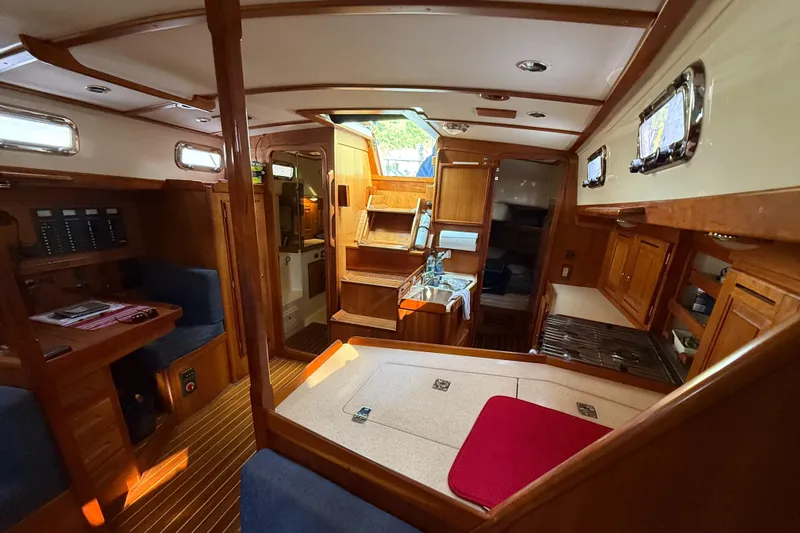 Nino Yacht Photos Pics Interior of 2007 Tartan 4100 sailboat with wood finish and compact kitchen area.