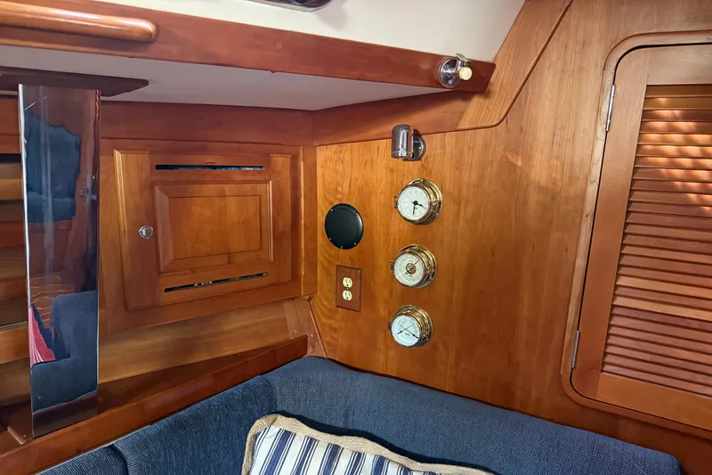 Nino Yacht Photos Pics Interior of 2007 Tartan 4100 sailboat with wooden paneling and nautical instruments.