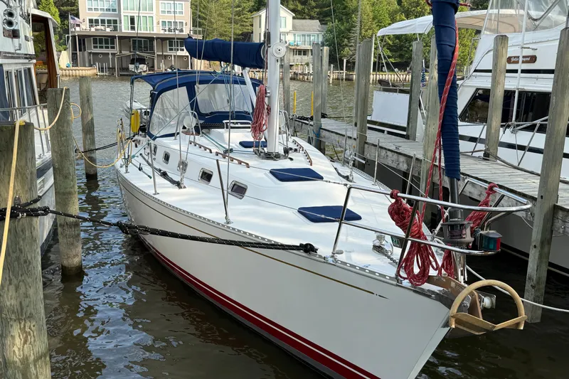 Nino Yacht Photos Pics Sailboat Tartan 4100, 2007 model, docked in a marina with surrounding boats.