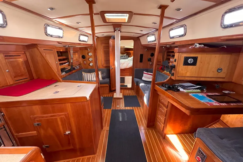 Nino Yacht Photos Pics Interior of 2007 Tartan 4100 sailboat with wooden furnishings and cozy seating.