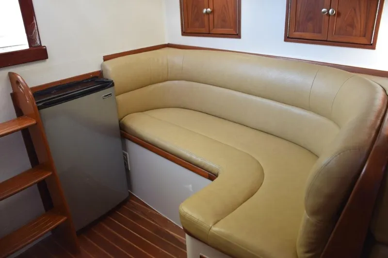 Osprey Yacht Photos Pics L-shape settee and refrigerator. Small cabinet storage above