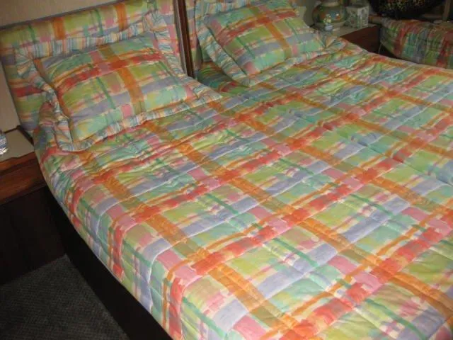  Yacht Photos Pics Colorful plaid bedding on a Chris-Craft Constellation 1984 boat bed.