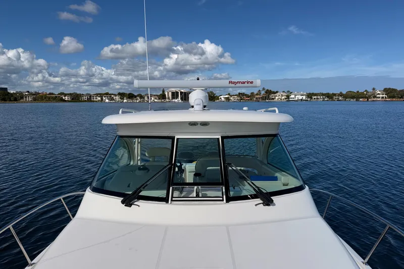  Yacht Photos Pics 2010 Pursuit OS 345 Offshore boat on calm water with clear sky.