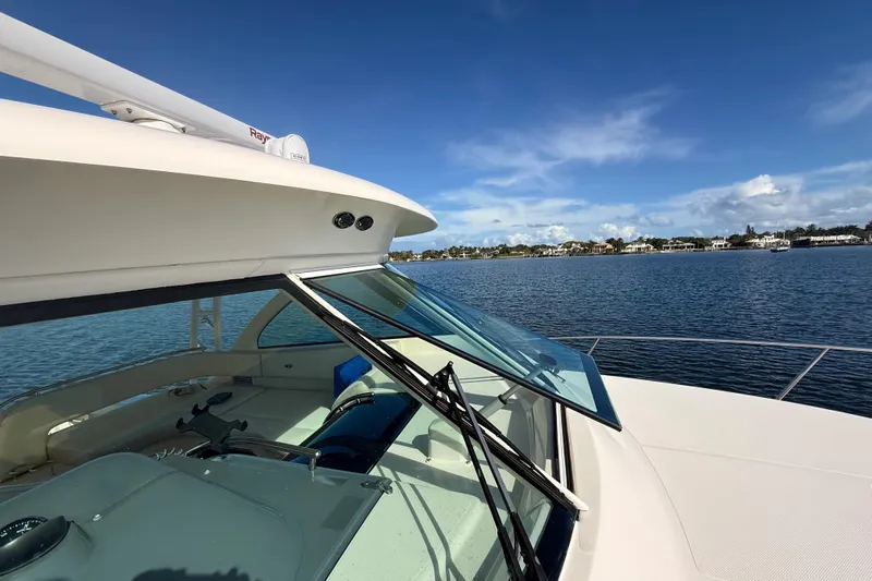  Yacht Photos Pics 2010 Pursuit OS 345 Offshore boat on calm water under clear blue sky.