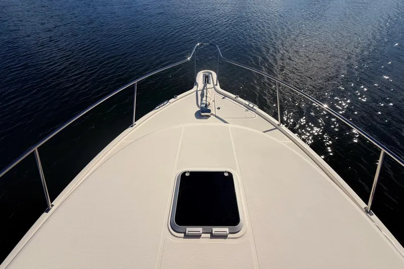  Yacht Photos Pics Bow view of 2010 Pursuit OS 345 Offshore boat on calm water.