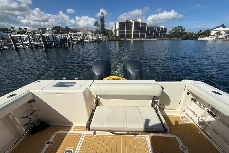  Yacht Photos Pics 2010 Pursuit OS 345 Offshore boat on water, featuring dual engines and spacious deck.