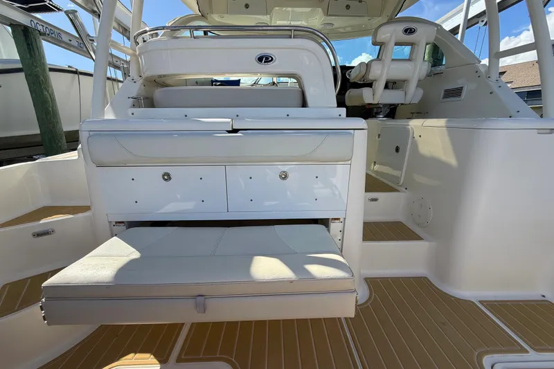  Yacht Photos Pics 2010 Pursuit OS 345 Offshore boat interior with seating and storage compartments.