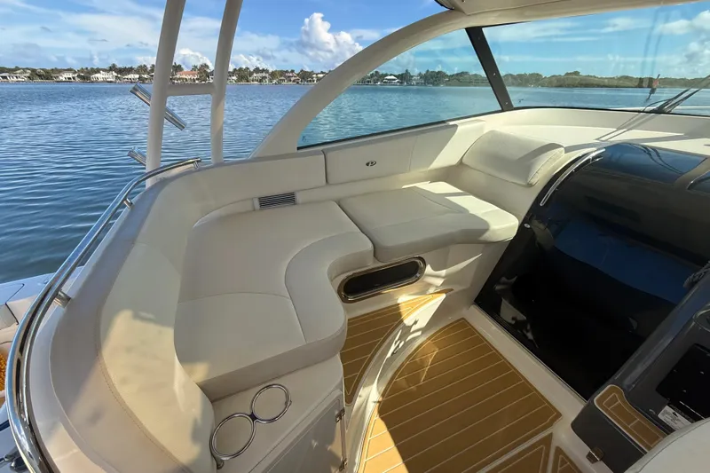  Yacht Photos Pics 2010 Pursuit OS 345 Offshore boat interior with white seating and wooden flooring.