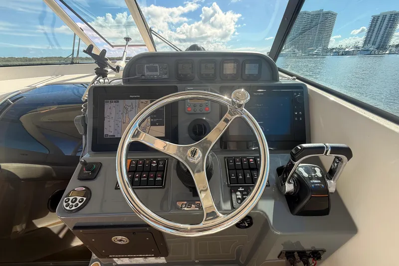  Yacht Photos Pics 2010 Pursuit OS 345 Offshore boat helm with navigation controls and steering wheel.