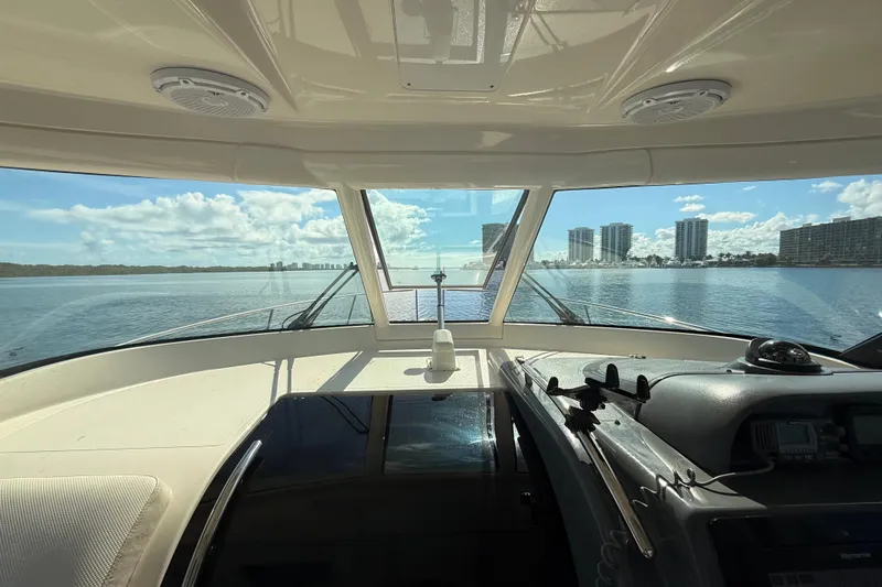  Yacht Photos Pics Interior view from 2010 Pursuit OS 345 Offshore boat, overlooking calm waters and city skyline.