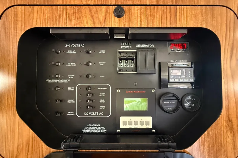  Yacht Photos Pics Electrical control panel of a 2010 Pursuit OS 345 Offshore boat, featuring various switches and gauges.