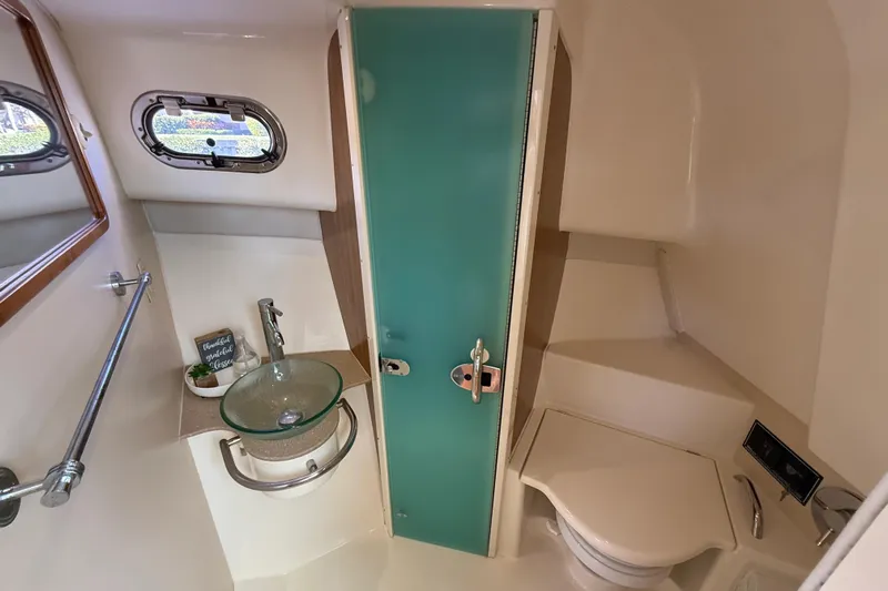  Yacht Photos Pics 2010 Pursuit OS 345 Offshore boat bathroom with glass sink and compact toilet.