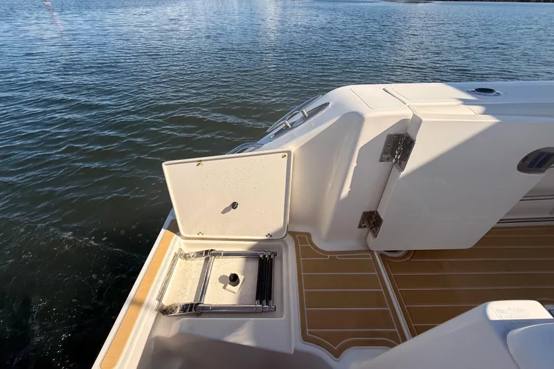  Yacht Photos Pics 2010 Pursuit OS 345 Offshore boat deck with open hatch and ladder.