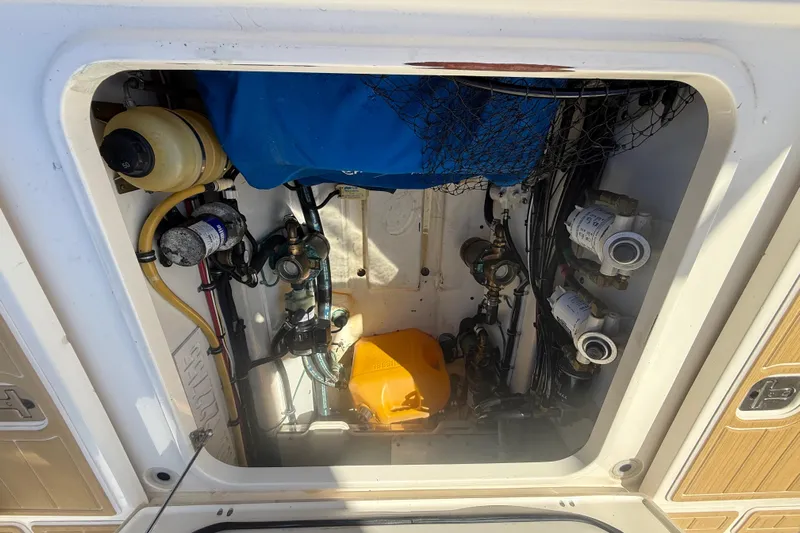  Yacht Photos Pics 2010 Pursuit OS 345 Offshore engine compartment with various mechanical components and wiring.