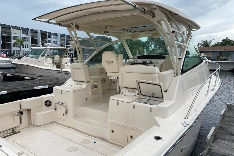  Yacht Photos Pics 2022 Grady-White Express 370 boat docked at marina, showcasing spacious cockpit and seating.