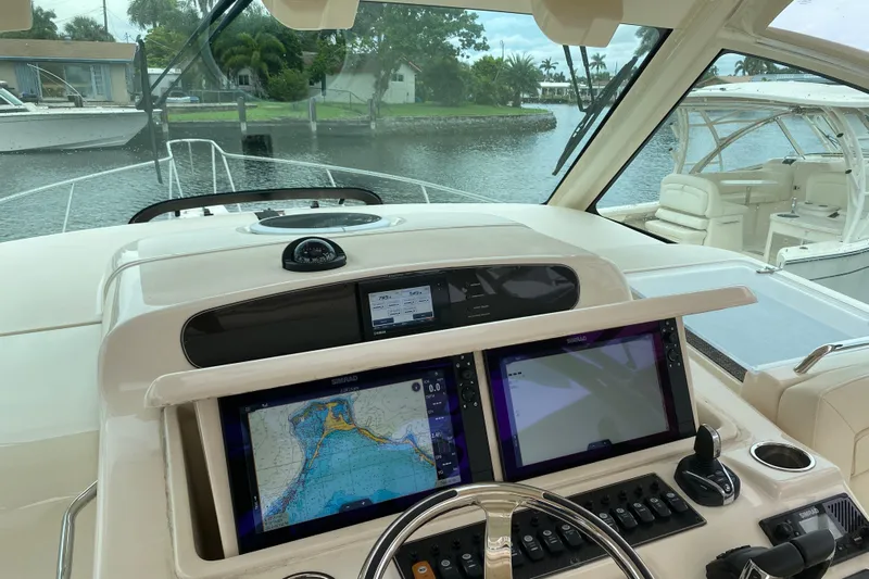  Yacht Photos Pics 2022 Grady-White Express 370 helm with navigation screens and steering wheel.