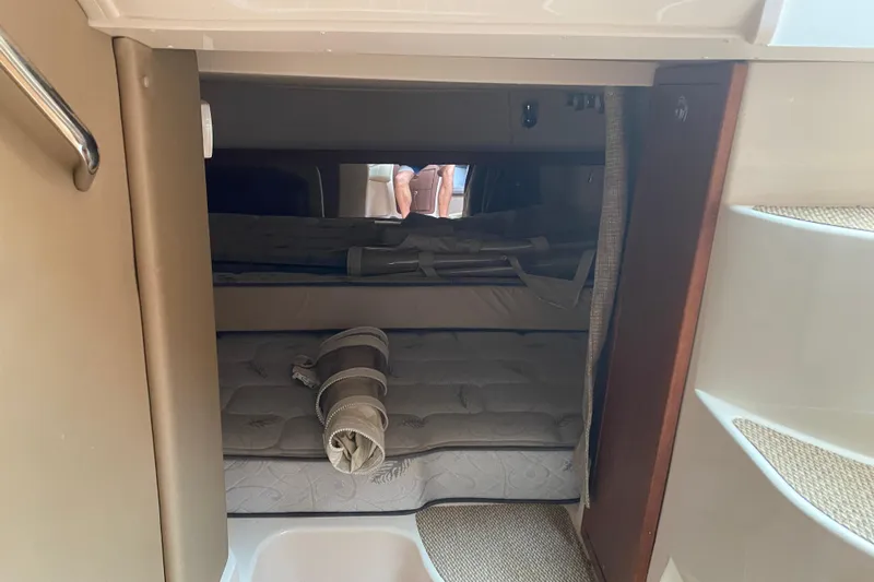  Yacht Photos Pics 2022 Grady-White Express 370 cabin interior with cozy sleeping area and rolled bedding.