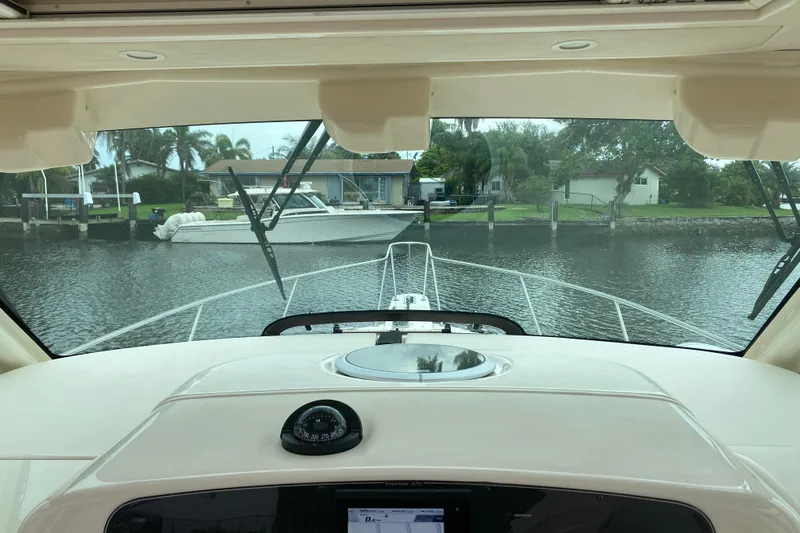  Yacht Photos Pics Interior view from a 2022 Grady-White Express 370 boat, overlooking a serene waterfront.