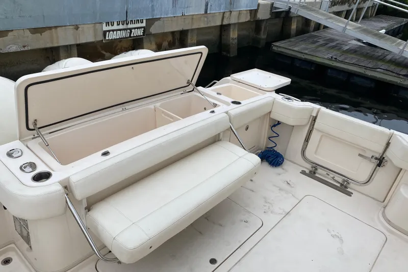  Yacht Photos Pics 2022 Grady-White Express 370 boat interior with open storage and seating at dock.