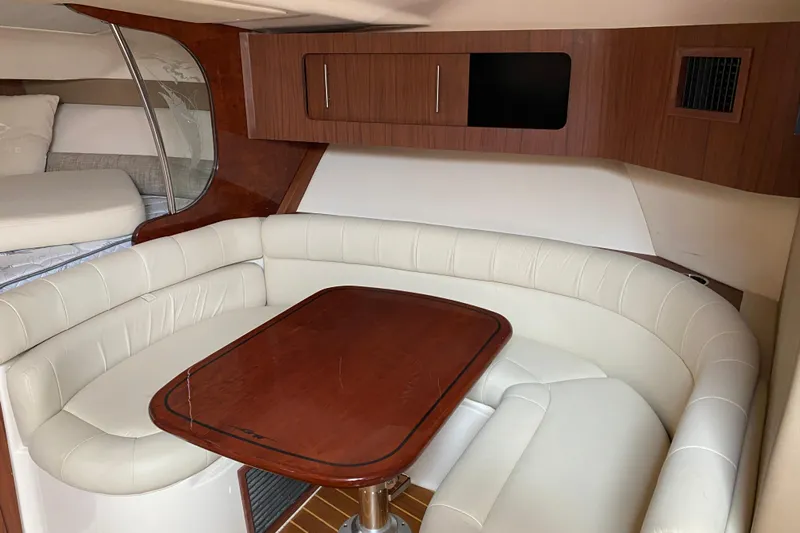  Yacht Photos Pics Luxurious interior of 2022 Grady-White Express 370 with elegant seating and wooden table.