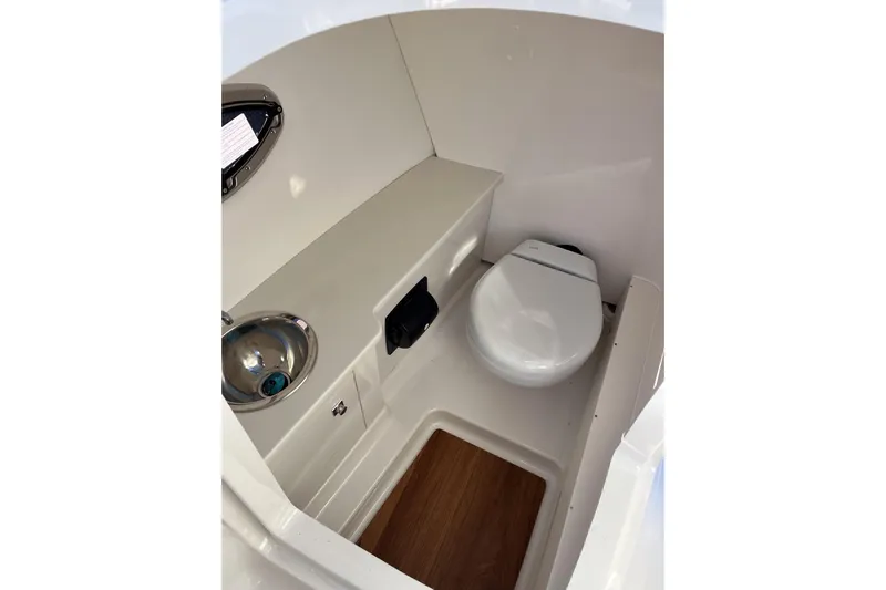  Yacht Photos Pics 2026 Robalo R257 Dual Console boat interior with compact toilet and sink.