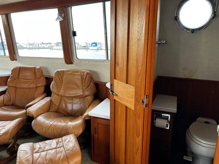 "o My Papa" Yacht Photos Pics Interior of 2003 Nordic Tug 52 with leather chairs and a compact bathroom.