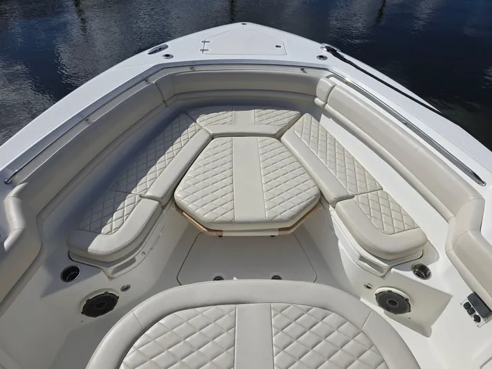  Yacht Photos Pics 2019 Boston Whaler 380 Outrage boat with luxurious white seating and diamond-patterned upholstery.