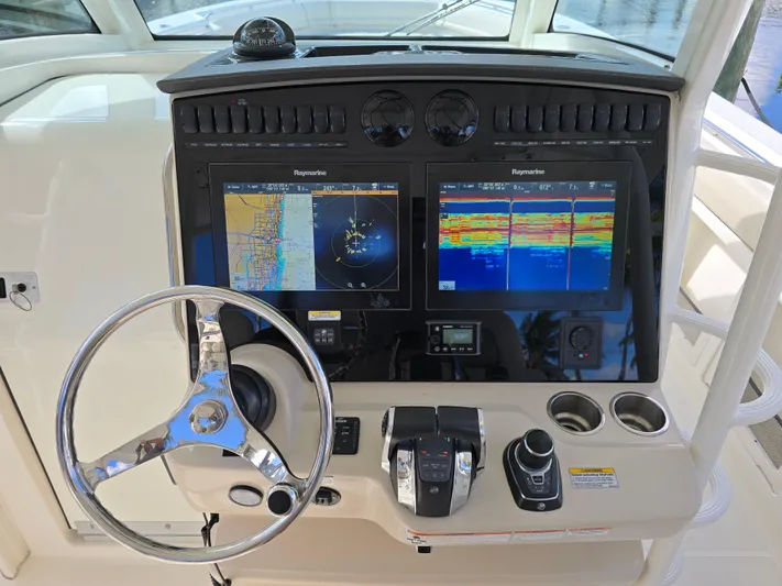  Yacht Photos Pics 2019 Boston Whaler 380 Outrage helm with dual navigation screens and steering wheel.