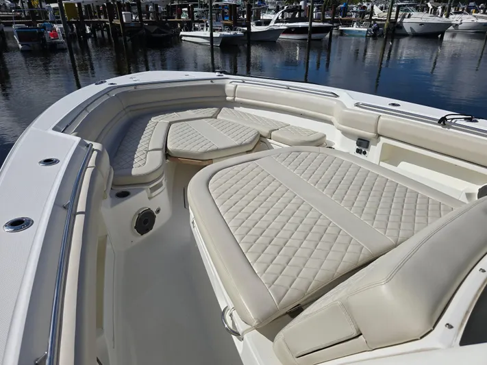  Yacht Photos Pics 2019 Boston Whaler 380 Outrage boat with luxurious seating in a marina setting.