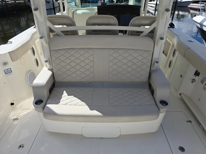  Yacht Photos Pics 2019 Boston Whaler 380 Outrage boat interior with cushioned seating and cup holders.