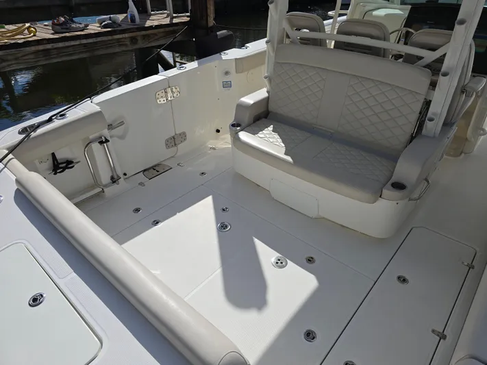  Yacht Photos Pics 2019 Boston Whaler 380 Outrage boat interior with cushioned seating and spacious deck.