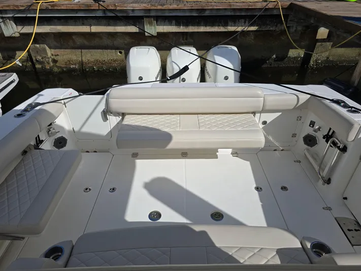  Yacht Photos Pics 2019 Boston Whaler 380 Outrage boat interior with seating and triple outboard engines.