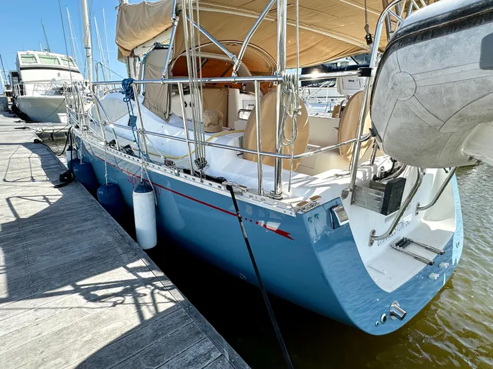 Sparrow Yacht Photos Pics Sailboat docked at marina, Saga 409 model, 2005, with beige canopy and blue hull.