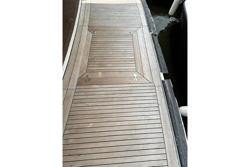 Sunshine Yacht Photos Pics Teak deck of 2010 Versilcraft Euroyacht Planet 125S Hardtop, featuring sleek wood design.