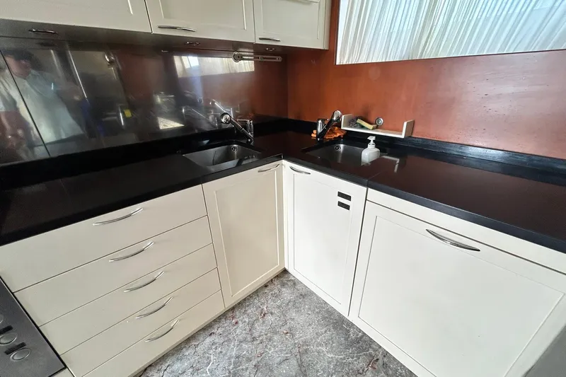 Sunshine Yacht Photos Pics Modern kitchen interior on 2010 Versilcraft Euroyacht Planet 125S Hardtop, featuring sleek cabinetry and countertops.