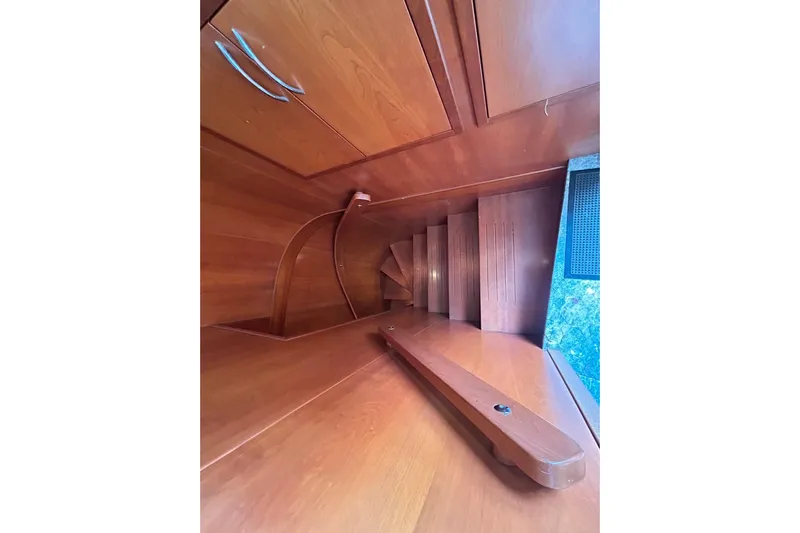 Sunshine Yacht Photos Pics Wooden staircase inside 2010 Versilcraft Euroyacht Planet 125S Hardtop, featuring elegant cabinetry.