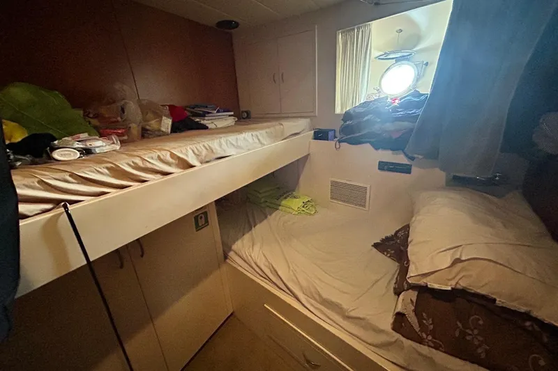 Sunshine Yacht Photos Pics Cozy cabin interior of 2010 Versilcraft Euroyacht Planet 125S with bunk beds and porthole.