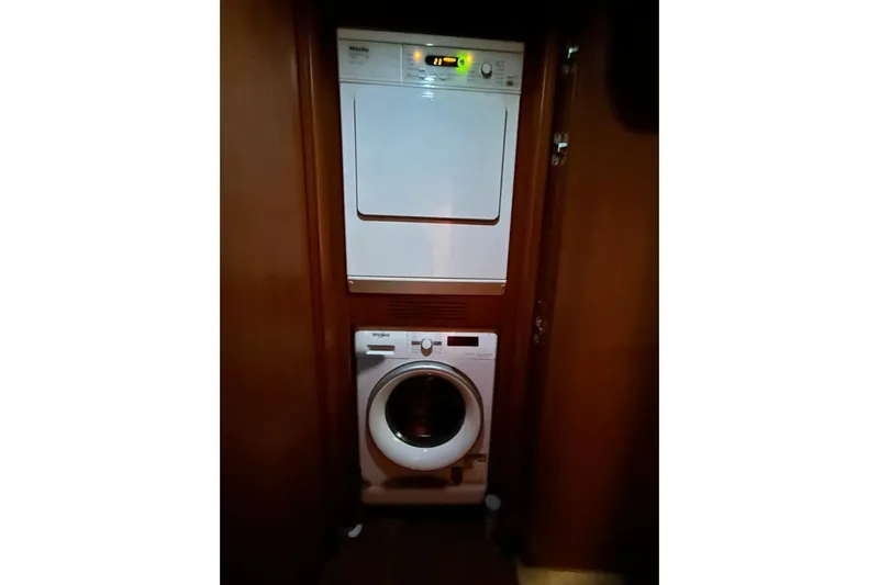 Sunshine Yacht Photos Pics Laundry area with washer and dryer on Versilcraft Euroyacht Planet 125S Hardtop, 2010 model.