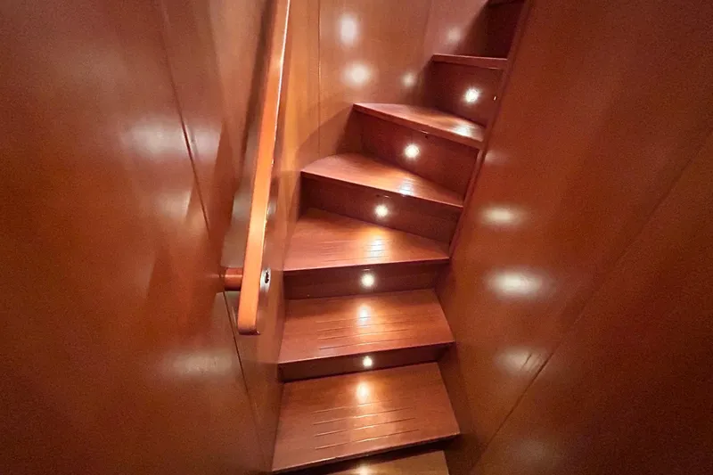 Sunshine Yacht Photos Pics Wooden staircase with ambient lighting on Versilcraft Euroyacht Planet 125S Hardtop, 2010 model.